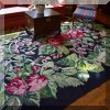 DR01. Woven rug with floral design. 